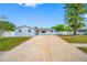 Charming single-story home with a long driveway, light blue paint, and a well-maintained front yard at 8409 Lantana Dr, Seminole, FL 33777