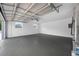 Garage with painted floor and newly painted white walls at 8409 Lantana Dr, Seminole, FL 33777
