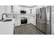 Kitchen with white cabinetry, stainless steel appliances, marble counters, and updated fixtures at 8409 Lantana Dr, Seminole, FL 33777