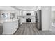 Updated kitchen featuring stainless steel appliances, white cabinets, and marble countertops at 8409 Lantana Dr, Seminole, FL 33777