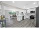 Updated kitchen featuring stainless steel appliances with an open view to the dining room at 8409 Lantana Dr, Seminole, FL 33777