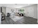 Bright living room with modern decor, hardwood floors, and a large window at 8409 Lantana Dr, Seminole, FL 33777