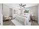 Bright bedroom with light gray walls, a ceiling fan, and two windows for natural light at 8409 Lantana Dr, Seminole, FL 33777