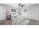 Bright bedroom with light gray walls, a ceiling fan, and two windows for natural light at 8409 Lantana Dr, Seminole, FL 33777