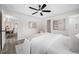 Bedroom featuring a ceiling fan, light gray walls, and easy access to the en-suite bathroom at 8409 Lantana Dr, Seminole, FL 33777