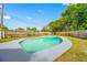 Backyard featuring a private pool surrounded by lush greenery and a wooden fence at 8409 Lantana Dr, Seminole, FL 33777