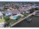Aerial view showcases waterfront property with a pool, patio, boat lift, and canal access at 8722 Hickorywood Ln, Tampa, FL 33615