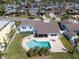Aerial view showcases a backyard oasis with a sparkling pool and convenient access to waterfront activities at 8722 Hickorywood Ln, Tampa, FL 33615