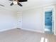 Bedroom featuring a ceiling fan, closet and a doorway into a bright blue bathroom at 8722 Hickorywood Ln, Tampa, FL 33615
