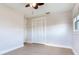 Bedroom with light hardwood floors, a closet with folding doors, and a ceiling fan at 8722 Hickorywood Ln, Tampa, FL 33615