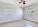 Inviting bedroom with natural light, neutral walls, and light hardwood flooring at 8722 Hickorywood Ln, Tampa, FL 33615