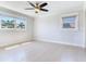 Bright bedroom with hardwood floors, neutral walls and a modern ceiling fan at 8722 Hickorywood Ln, Tampa, FL 33615