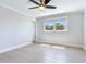 Bright bedroom with light wood floors, ceiling fan, and natural light from window at 8722 Hickorywood Ln, Tampa, FL 33615
