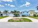 Charming light blue two-story home with lush tropical landscaping and a spacious circular driveway at 8722 Hickorywood Ln, Tampa, FL 33615