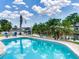 Scenic brick pool surrounded by lush landscaping with a waterfront view, providing a tranquil outdoor living experience at 8722 Hickorywood Ln, Tampa, FL 33615