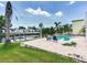 Outdoor pool area with waterfront views and ample seating surrounded by lush tropical landscaping at 8722 Hickorywood Ln, Tampa, FL 33615