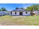 Backyard features white exterior with sliding glass door at 911 Kirkcaldy Way, Valrico, FL 33594
