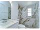 Updated bathroom boasts quartz countertop, tiled shower with modern fixtures at 911 Kirkcaldy Way, Valrico, FL 33594