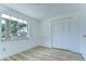 Bedroom features wood-look floors, window views and large closet at 911 Kirkcaldy Way, Valrico, FL 33594