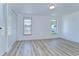 Bright bedroom features wood-look floors, two windows and a large closet at 911 Kirkcaldy Way, Valrico, FL 33594