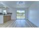 Bright dining area features wood floors and glass sliding doors to the backyard at 911 Kirkcaldy Way, Valrico, FL 33594