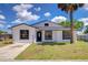 Charming home exterior with new front door, landscaping and a large palm tree at 911 Kirkcaldy Way, Valrico, FL 33594