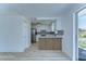 Bright kitchen with white cabinets and stainless steel refrigerator at 911 Kirkcaldy Way, Valrico, FL 33594