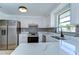 Renovated kitchen with stainless steel appliances and stone countertops at 911 Kirkcaldy Way, Valrico, FL 33594