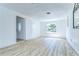 Bright living room features wood-look floors and front door entrance at 911 Kirkcaldy Way, Valrico, FL 33594