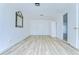 Living room features wood-look floors, modern ceiling and a decorative mirror at 911 Kirkcaldy Way, Valrico, FL 33594