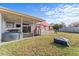 Fenced backyard features covered patio and outdoor cooking area at 3748 Redwood Dr, Holiday, FL 34691