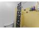 Cozy bathroom featuring a walk-in shower with yellow tiling and a spooky Halloween-themed shower curtain at 3748 Redwood Dr, Holiday, FL 34691