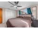 Primary bedroom with a window, curtains, and fan at 3748 Redwood Dr, Holiday, FL 34691