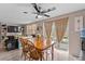 Dining room featuring hardwood flooring, modern lighting, and sliding glass doors, that bring in plenty of natural light at 3748 Redwood Dr, Holiday, FL 34691