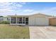 Charming single-story home features a stone facade, screened porch, and attached garage at 3748 Redwood Dr, Holiday, FL 34691