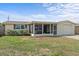 Inviting single-story home with stone accents, a screened porch, and well-maintained lawn at 3748 Redwood Dr, Holiday, FL 34691