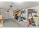 A well lit garage featuring a washer and dryer and ample storage with a multiple car garage door at 3748 Redwood Dr, Holiday, FL 34691