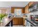 Bright kitchen features wood cabinets, white countertops and subway tile backsplash at 3748 Redwood Dr, Holiday, FL 34691