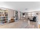 Cozy living room featuring built-in bookshelves, neutral paint, modern flooring, and bright, natural light at 3748 Redwood Dr, Holiday, FL 34691