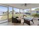 Cozy screened porch with outdoor furniture, offering a comfortable and relaxing space at 3748 Redwood Dr, Holiday, FL 34691
