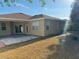 A view of the home's backyard featuring a concrete patio and a stone area enclosed with brick at 11318 Laurel Brook Ct, Riverview, FL 33569