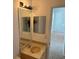 Bathroom featuring a granite countertop, cabinets, and a mirror with lighting at 11318 Laurel Brook Ct, Riverview, FL 33569