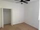 Bedroom with neutral carpet, white walls, ceiling fan and closet with open doors at 11318 Laurel Brook Ct, Riverview, FL 33569