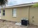 Tan exterior of a home with white windows and an air conditioning unit at 11318 Laurel Brook Ct, Riverview, FL 33569