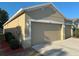 Garage showcasing a two-car garage and a well maintained lawn at 11318 Laurel Brook Ct, Riverview, FL 33569