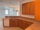 Kitchen featuring a double sink, wood cabinets, and tile flooring at 11318 Laurel Brook Ct, Riverview, FL 33569