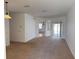 Open living area showcasing neutral carpet, fresh paint, and access to outdoor spaces at 11318 Laurel Brook Ct, Riverview, FL 33569