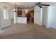 Open concept living room and kitchen with tile flooring and natural light at 11318 Laurel Brook Ct, Riverview, FL 33569