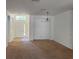 Spacious living room with carpet flooring, white walls, and natural light coming from the front door at 11318 Laurel Brook Ct, Riverview, FL 33569