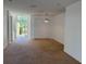 Living room featuring carpet flooring, a white door, and natural light at 11318 Laurel Brook Ct, Riverview, FL 33569